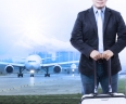 young man and traveling luggage staning in front of air plane taxi on airport runways preparing to fly use  image as people journey by air transport background